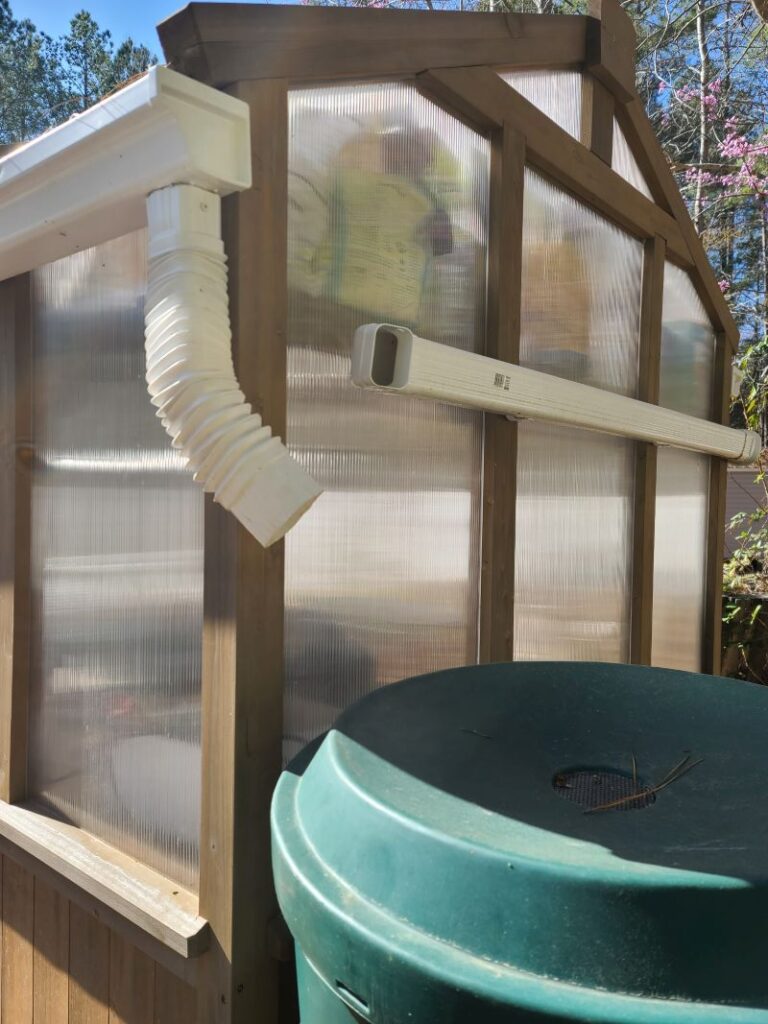 Rain Gutters on Greenhouse feeding rain barrel